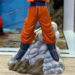 Dragon Ball History Box Kamehameha Goku Figure - Orange pants, blue boots, dynamic pose on rocky cloud base, vibrant collectible design