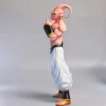 Dragon Ball - Majin Buu Statue: Kid Buu variant with pink skin, muscular physique, white pants featuring black/gold accents, and iconic head-tilted pose, hand near face. Collectible anime figure design.